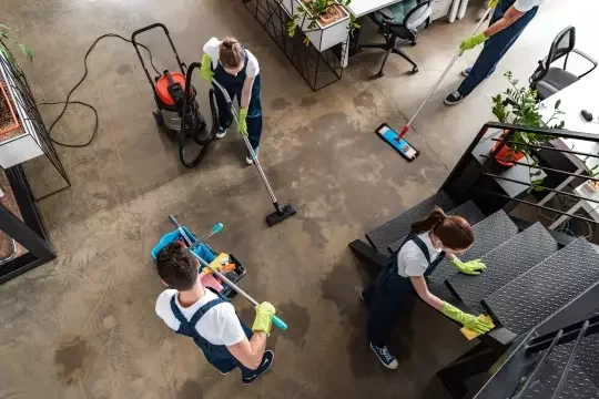 Cleaning operatives in an office space from a birds-eye view.